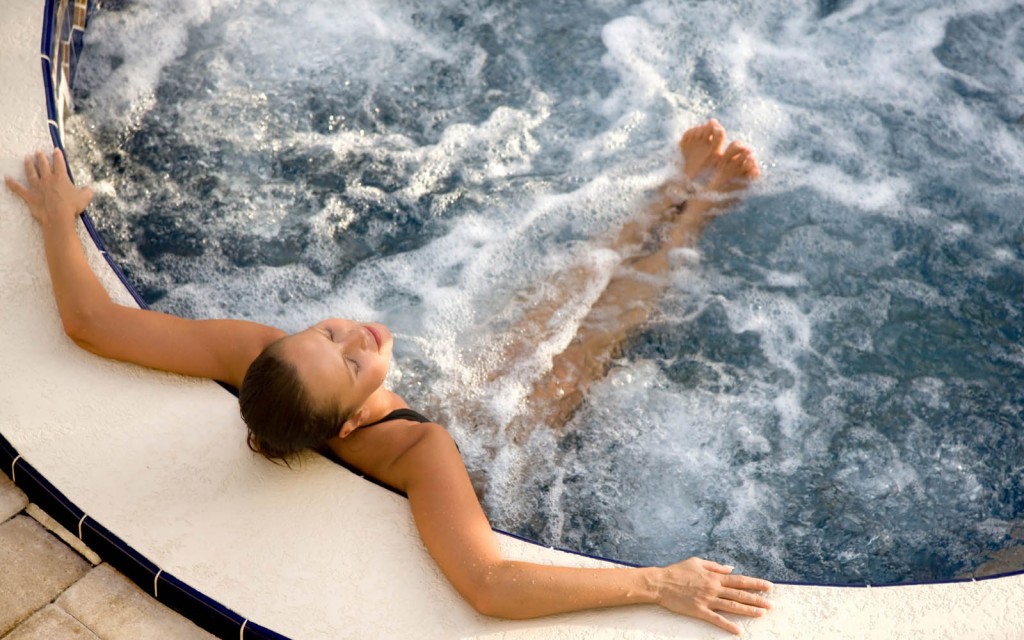woman relaxing in an outdoor jacuzzi
